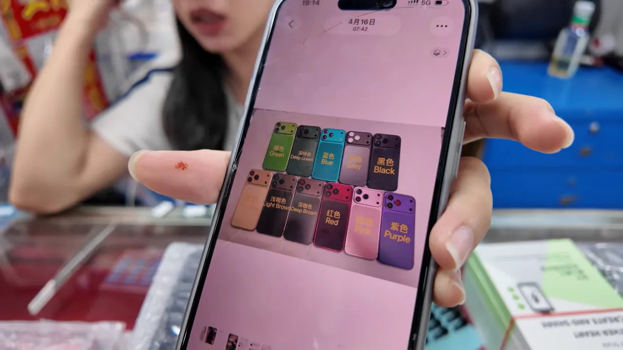 Coque rose personnalisée d'iPhone avec écran allumé posée dans un stand de réparation