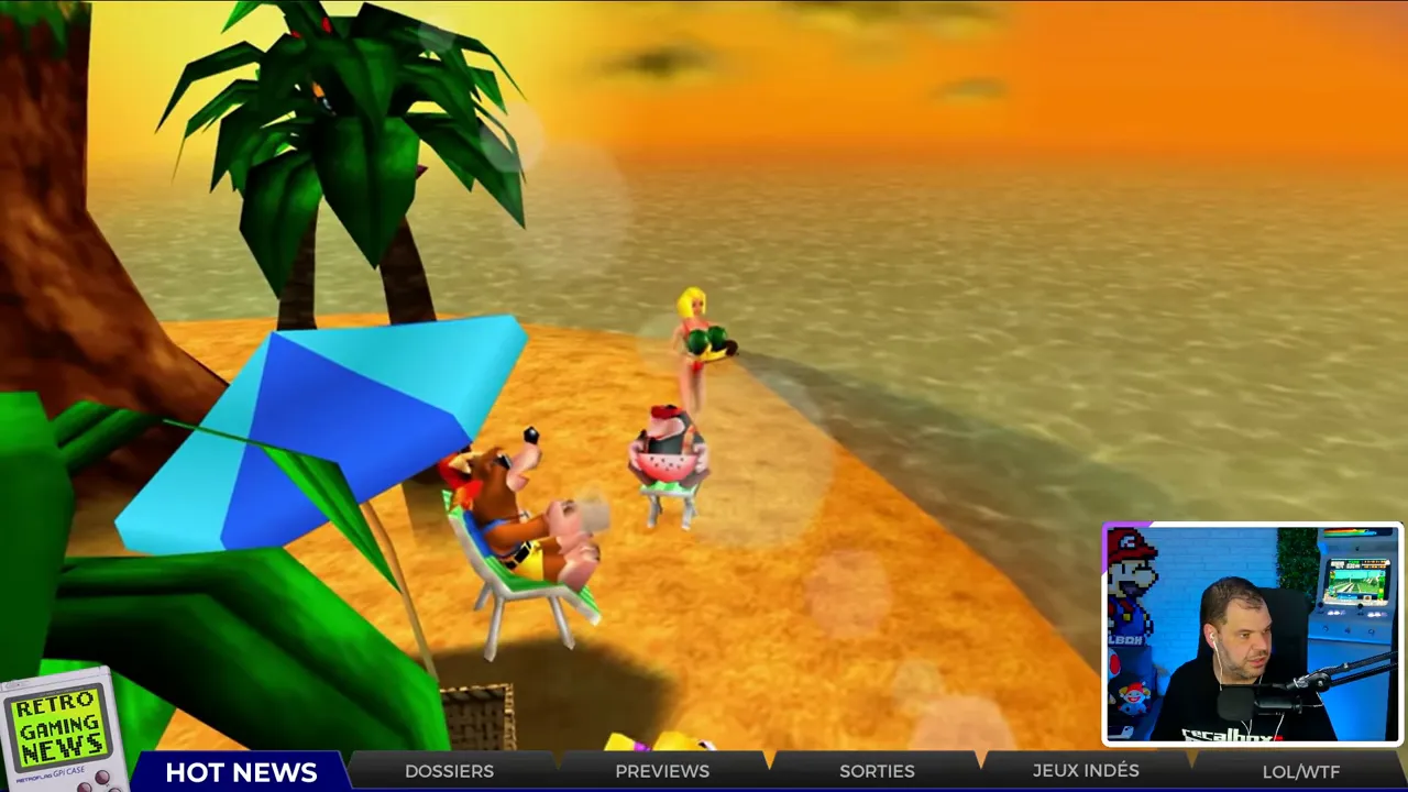 Capture du port PC de Banjo‑Kazooie montrant une plage au coucher de soleil, vignette du présentateur en bas à droite.