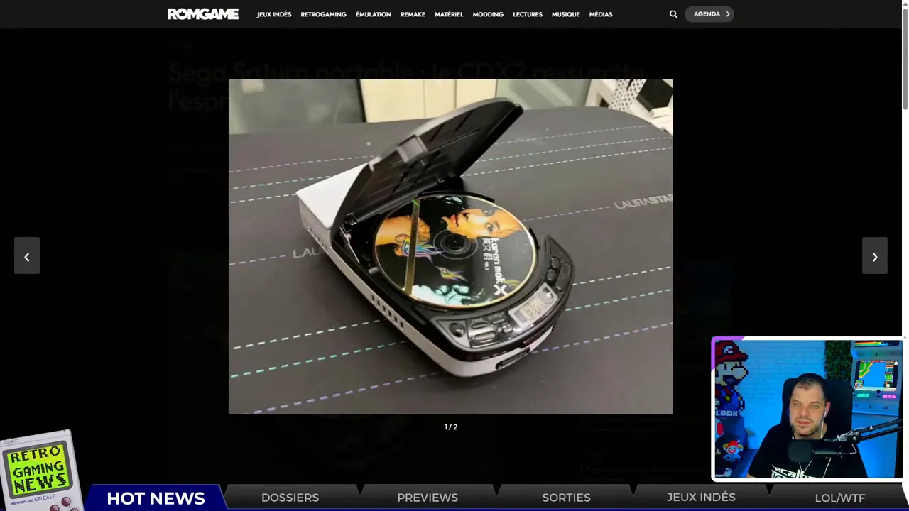 Prototype Sega Saturn portable logé dans un boîtier type Diskman, vue de dessus du lecteur optique ouvert avec un disque à l'intérieur