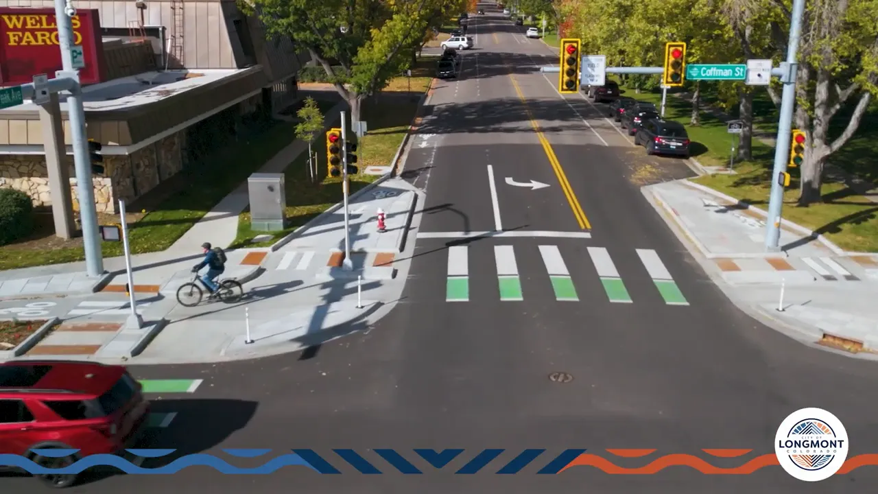 Aerial view of a protected intersection in Longmont showing corner islands, green bike crossings, holding areas and pedestrian crosswalks