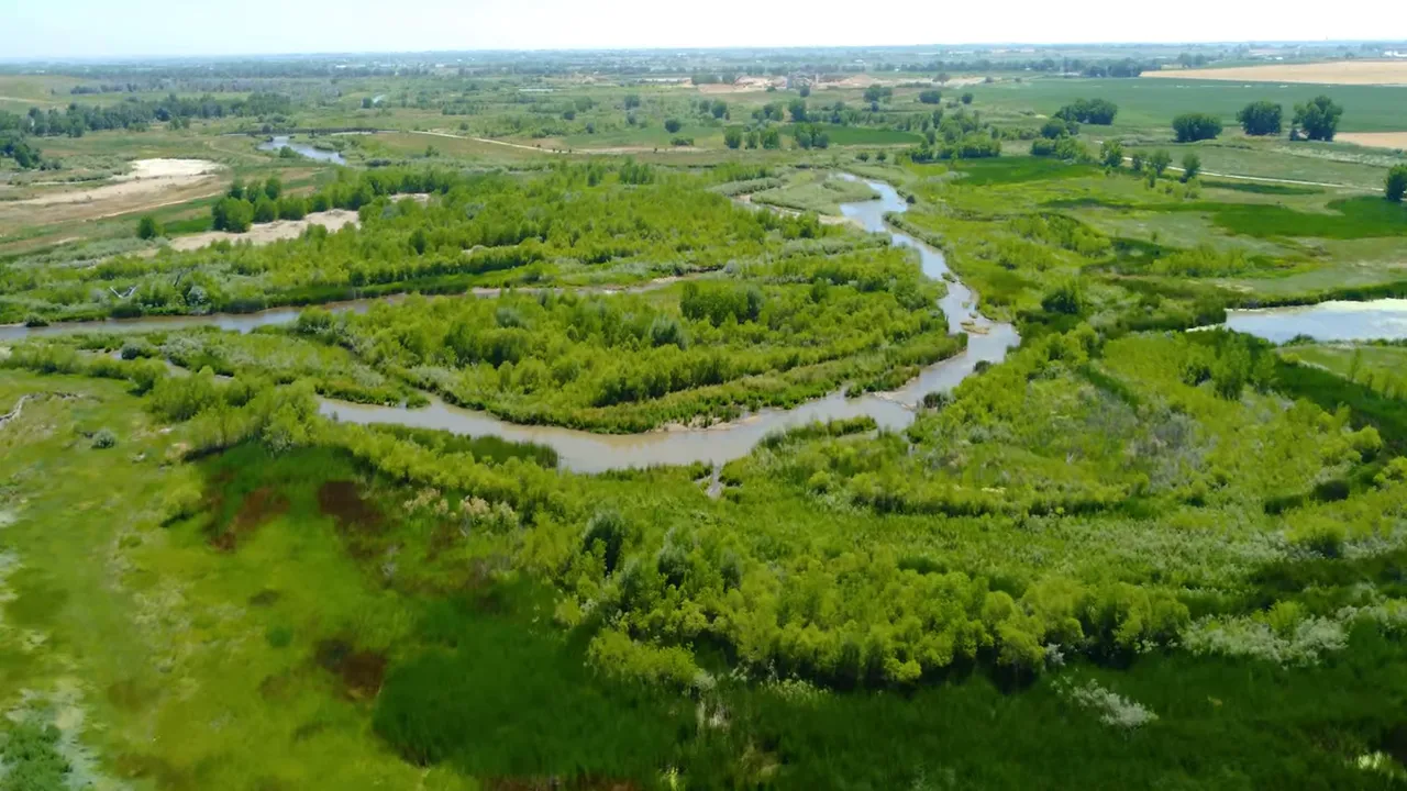People tubing on the St. Vrain River in spring