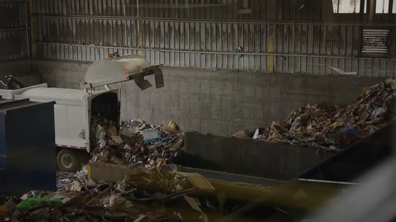 Where Does My Recycling Go? A Longmont Guide to Recycling Right 4 Recycling truck unloading mixed materials onto the tipping floor of an indoor sorting facility with large piles of recyclables