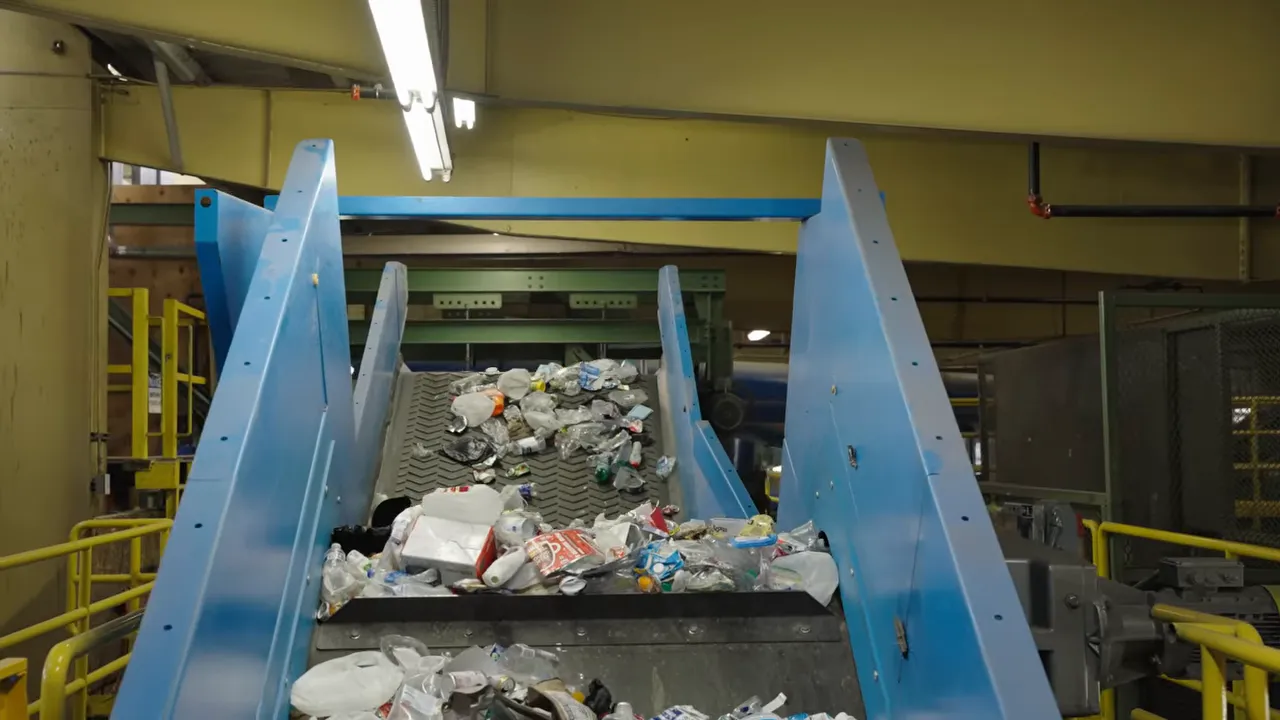 Where Does My Recycling Go? A Longmont Guide to Recycling Right 8 Mixed recyclables traveling up a conveyor belt inside a sorting facility