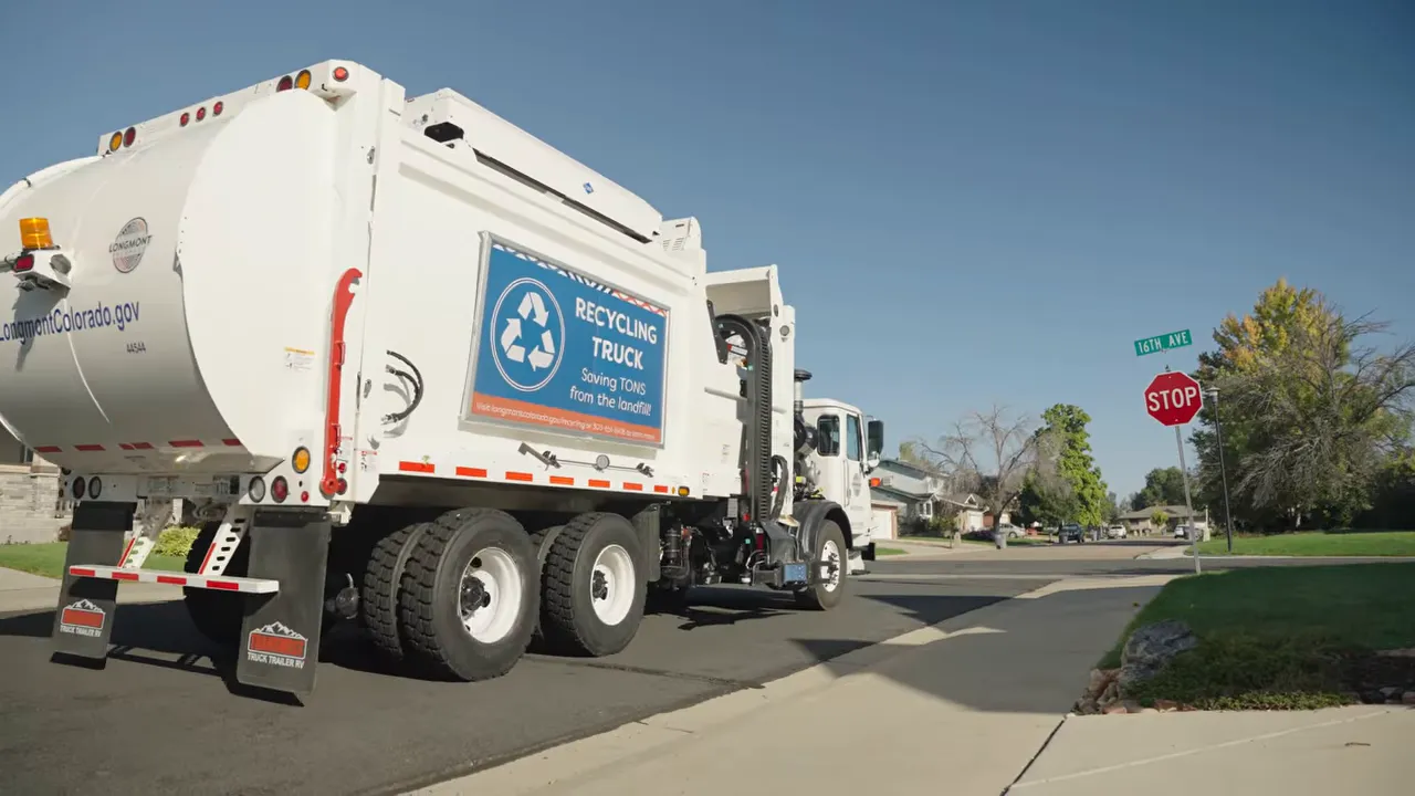 Where Does My Recycling Go? A Longmont Guide to Recycling Right 9 Recycling truck driving through a neighborhood with a visible 'Recycling Truck' sign on the side