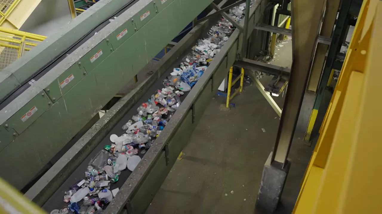 Where Does My Recycling Go? A Longmont Guide to Recycling Right 7 Overhead view of mixed recyclables moving on a long conveyor inside a recycling facility