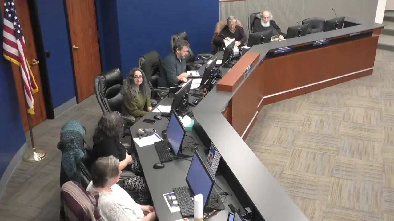 Wide overhead view of the Historic Preservation Commission dais with multiple members seated around a curved desk and meeting monitors visible.