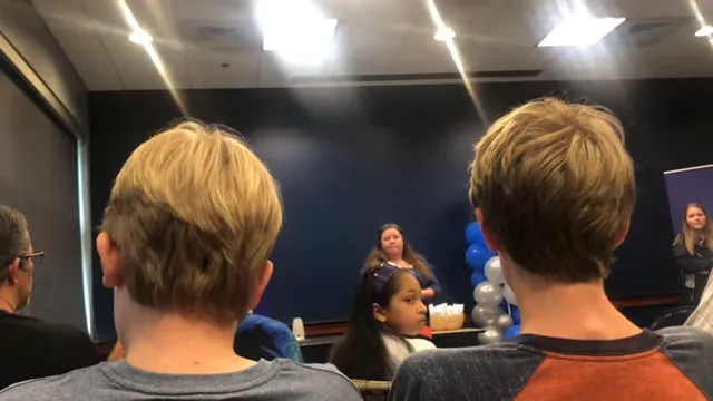 Admission staff talking about Apply in July at an admissions event