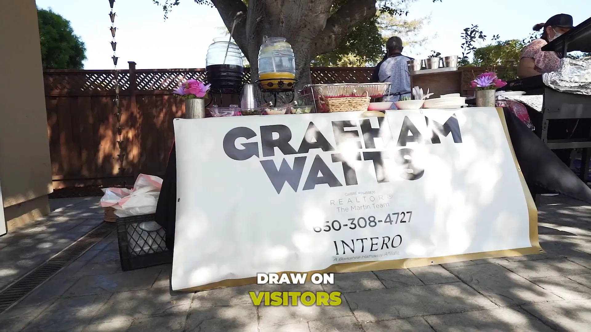 Grand opening event with visitors and a taco truck outside the home