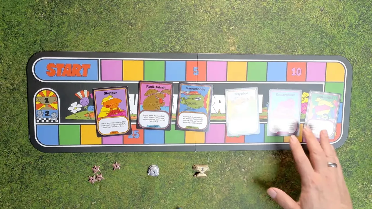 Spielplan Ruhiger Rasen mit ausgelegten Flitzpiepenkarten und Figuren