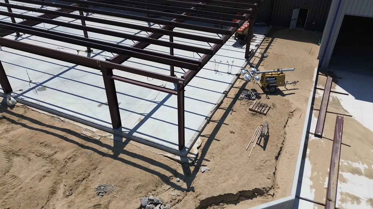 aerial construction view showing steel building frame and concrete slab