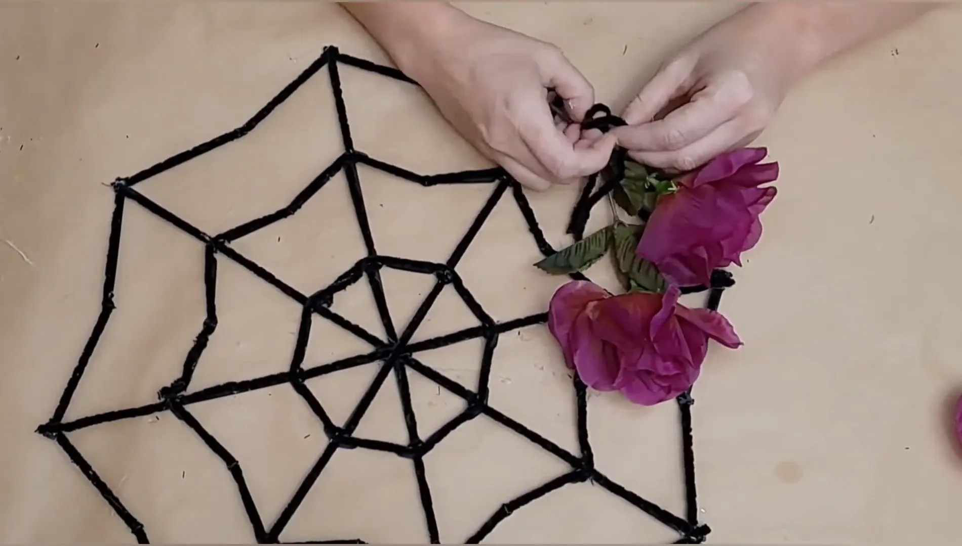 Attaching flowers to the spider web.