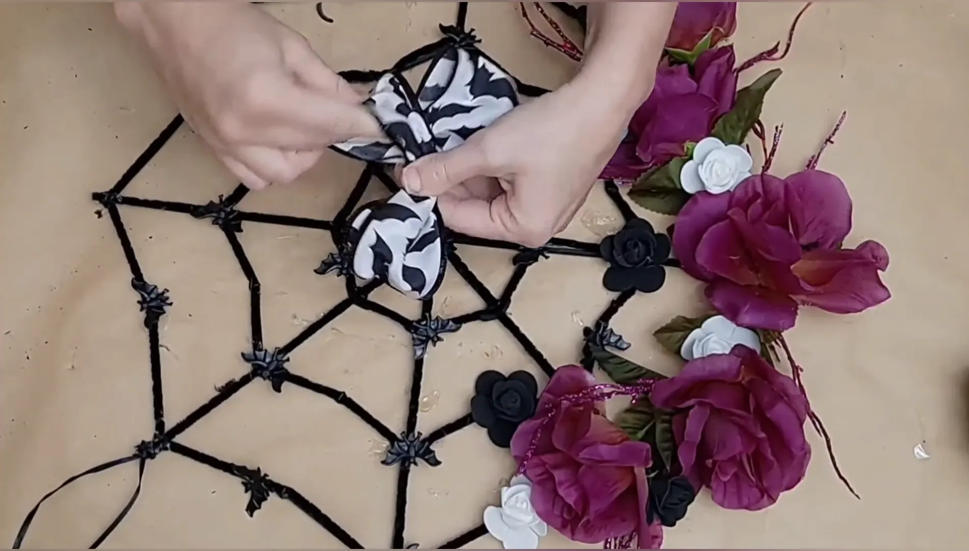 Attaching a bow to the spider web garland.