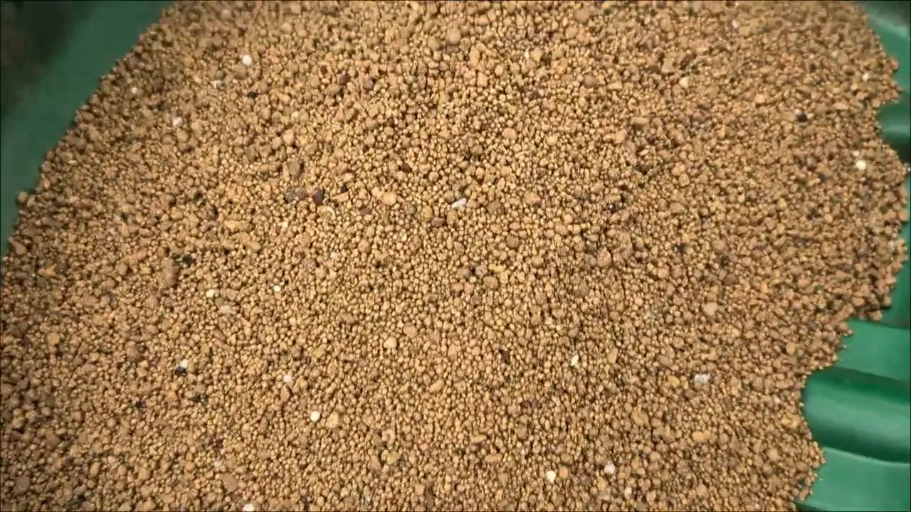 Granular preventative product loaded into a broadcast spreader before a lawn application