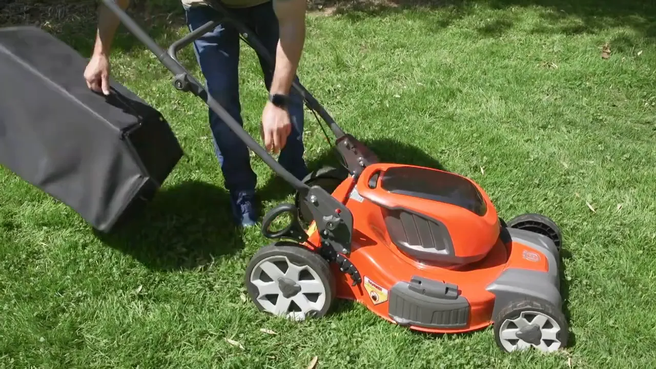 Mower cutting grass on a lawn to keep grass height down