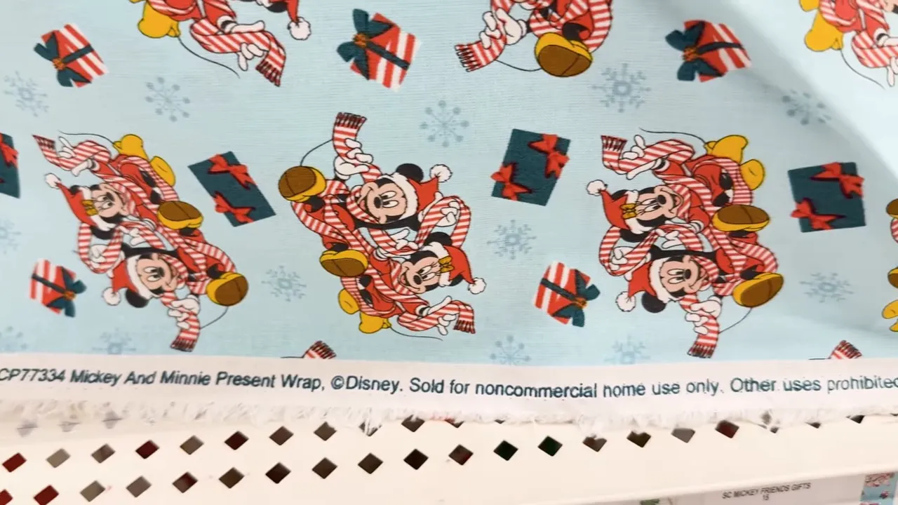 Close-up of Disney fabric selvage text reading sold for noncommercial home use only with Mickey and Minnie print