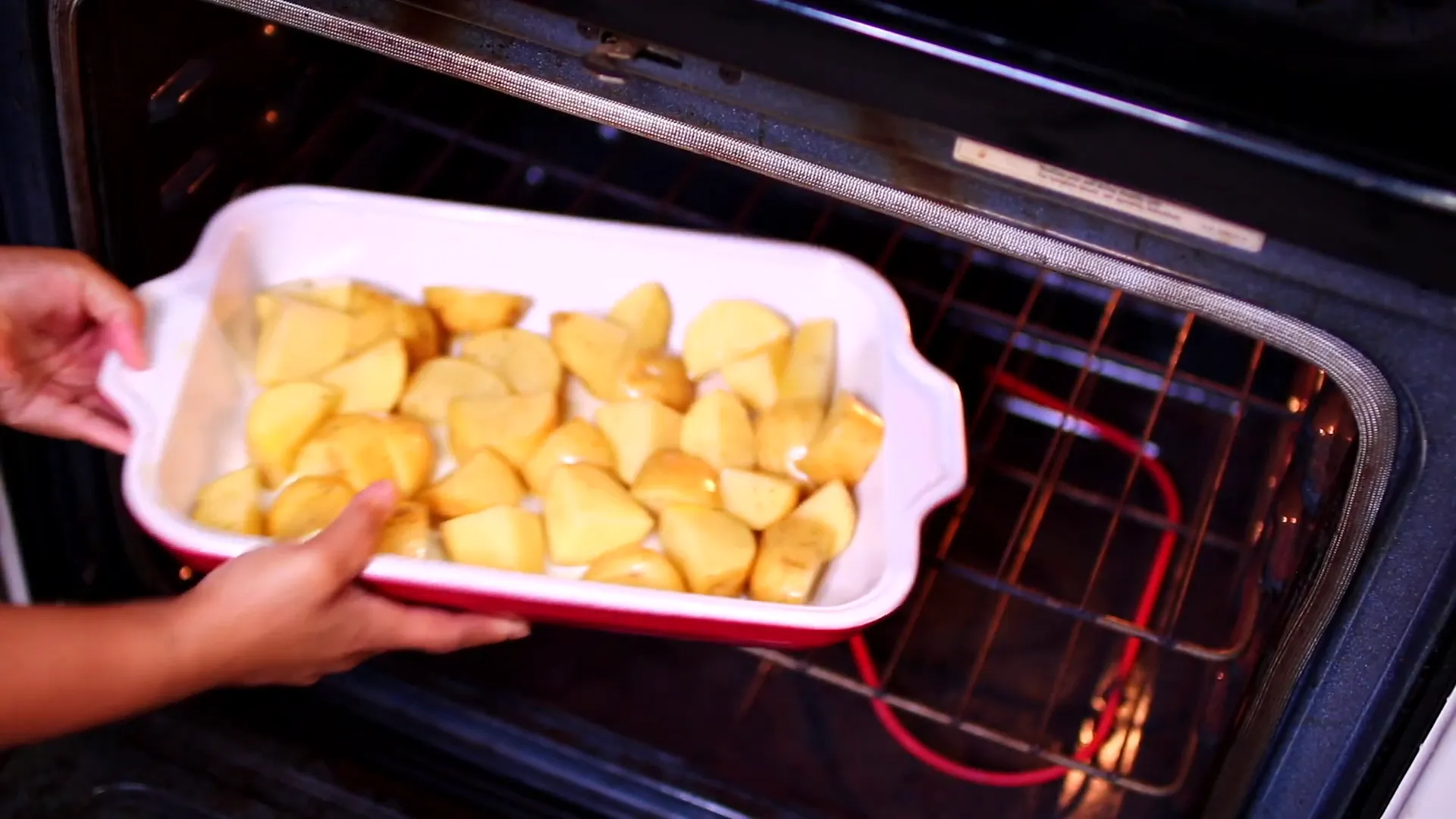 Placing potatoes in the oven