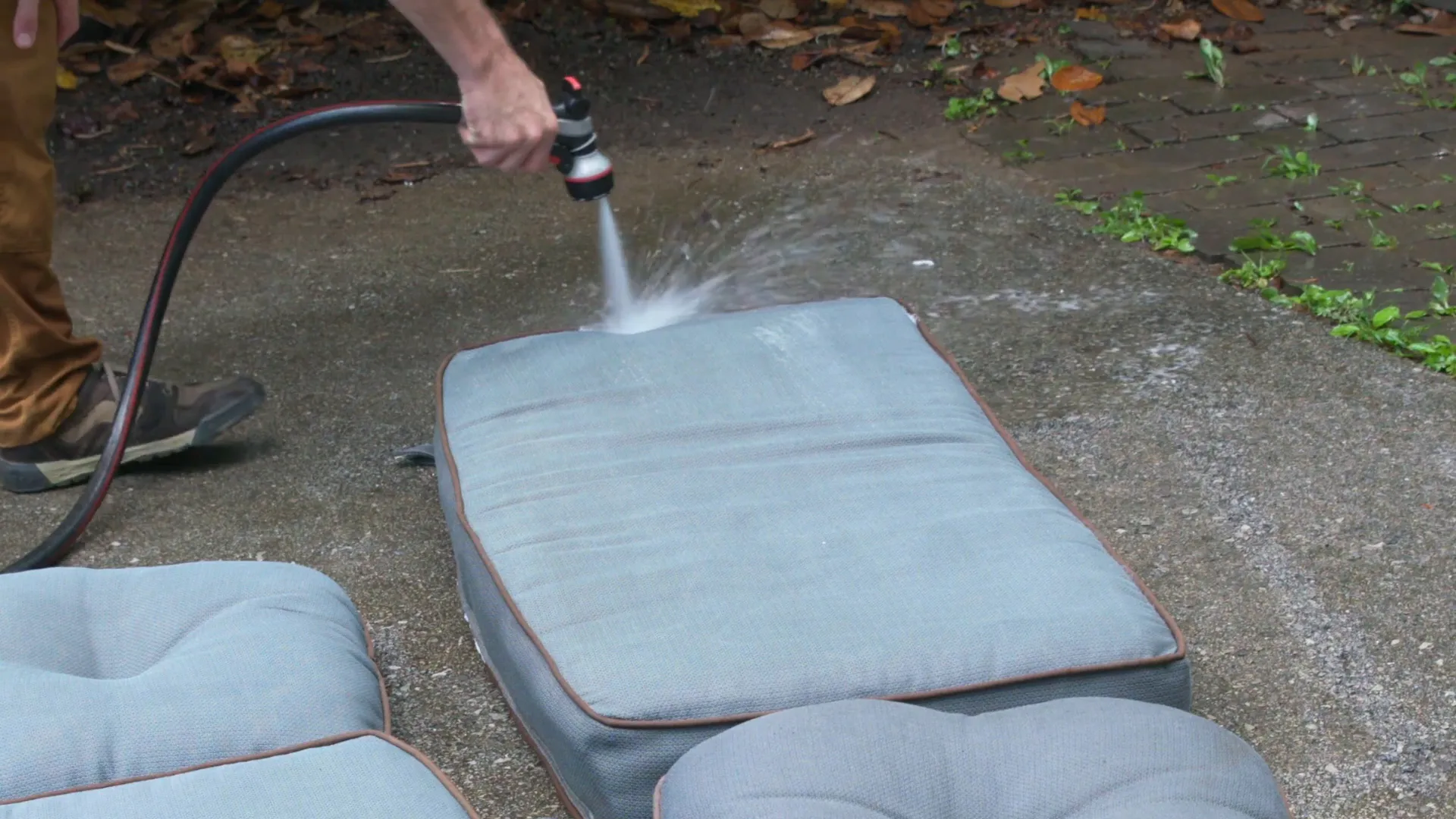 Rinsing outdoor cushions with a garden hose