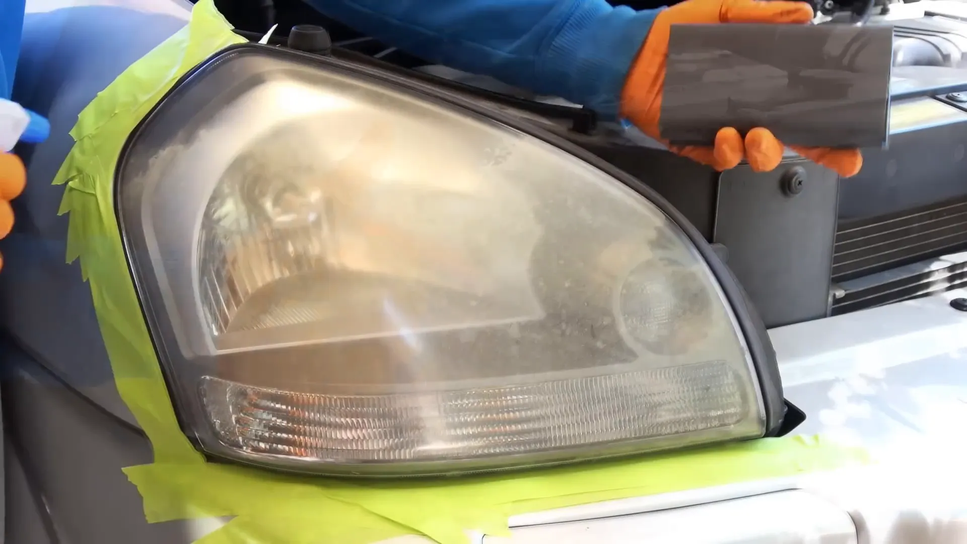 Applying tape around the headlights