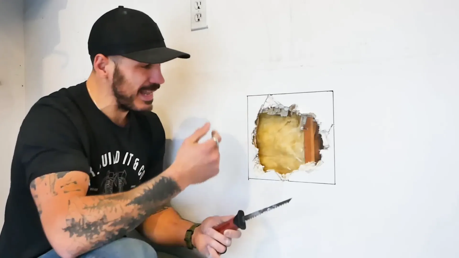 Drywall knife being used to clean up damaged area