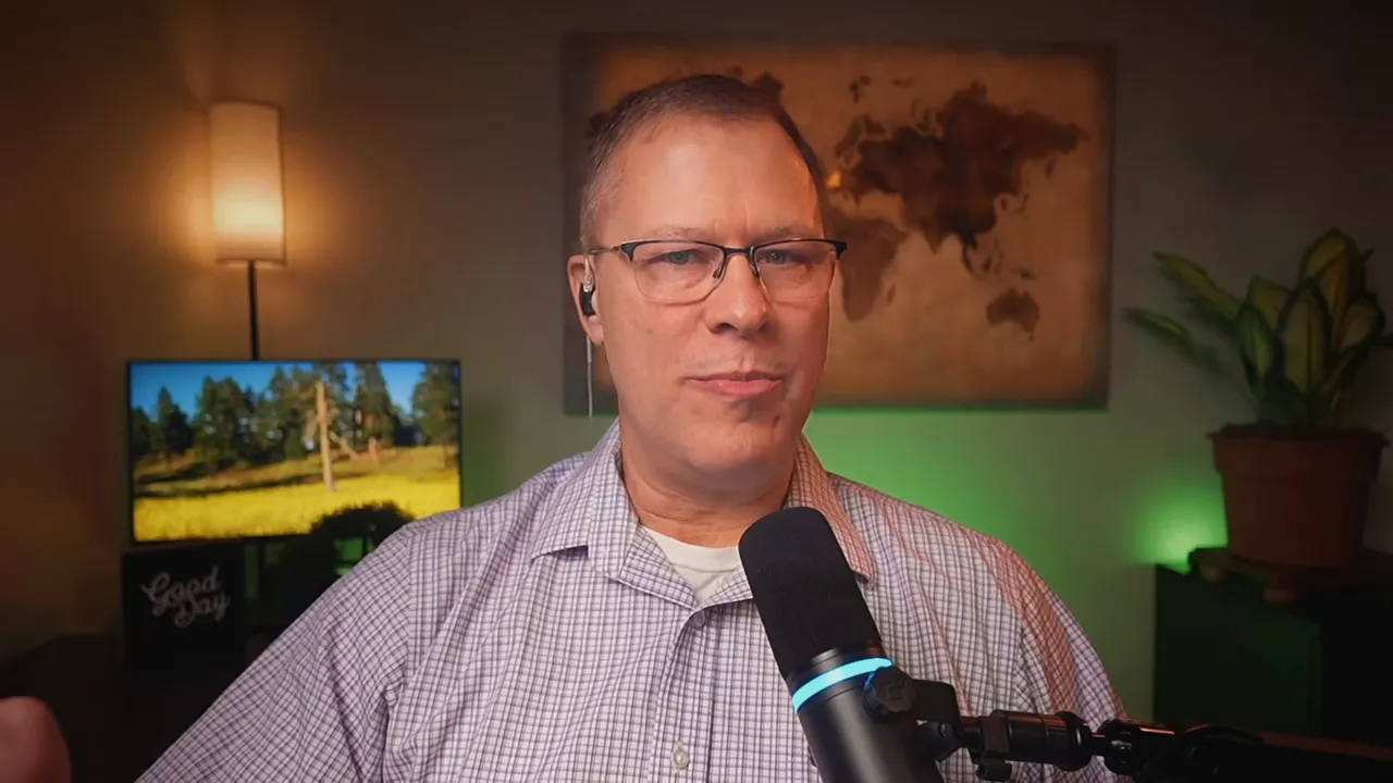 Bradley Charbonneau speaking into a podcast microphone on video