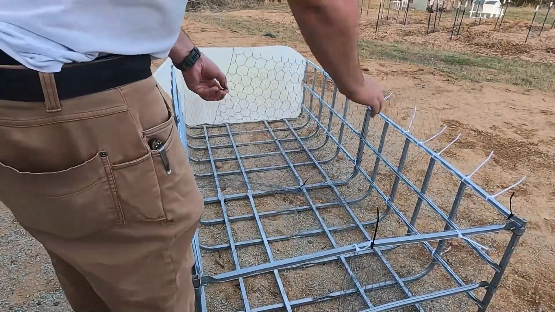 Attaching chicken wire with zip ties to the diy chicken tractor