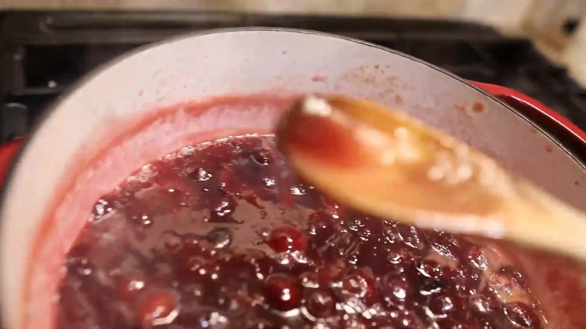 Testing the gel consistency before canning plums