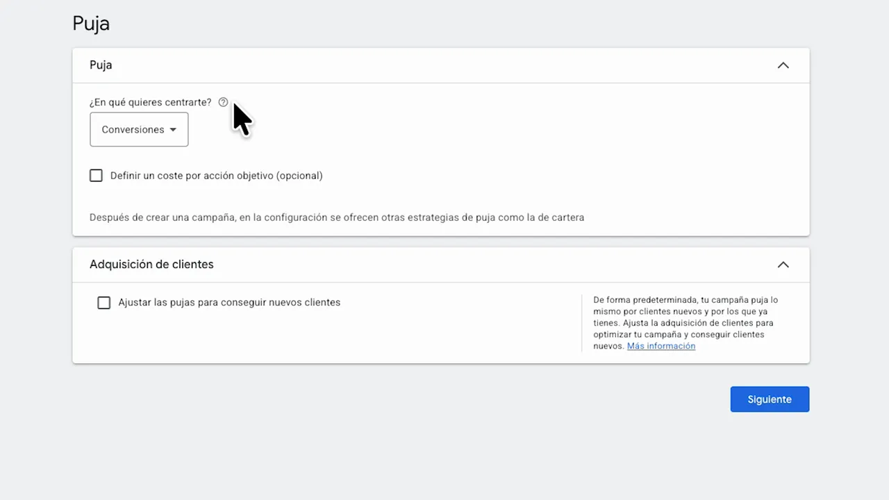 Zoom de la sección “Puja” en Google Ads mostrando el objetivo desplegable “Conversiones” y la opción de adquisición de clientes