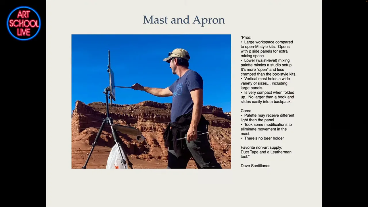 Plein-air artist using a mast-and-apron easel on a tripod in a rocky desert; palette and apron visible.
