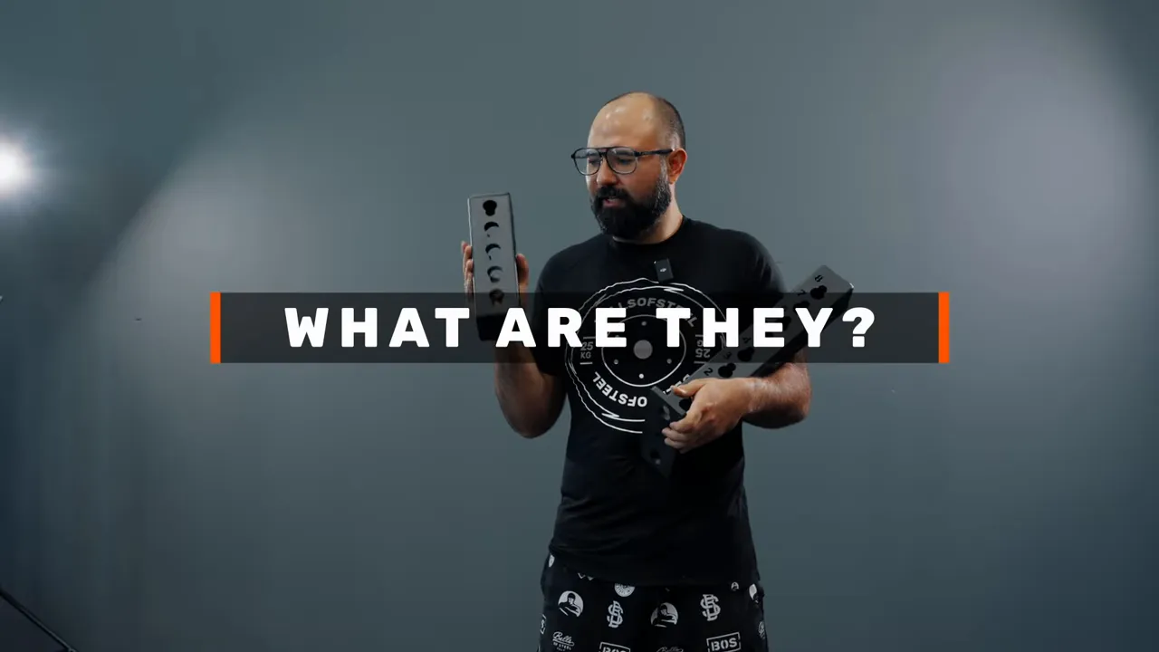 Presenter holding two black rack junction pieces with large 'WHAT ARE THEY?' title overlay