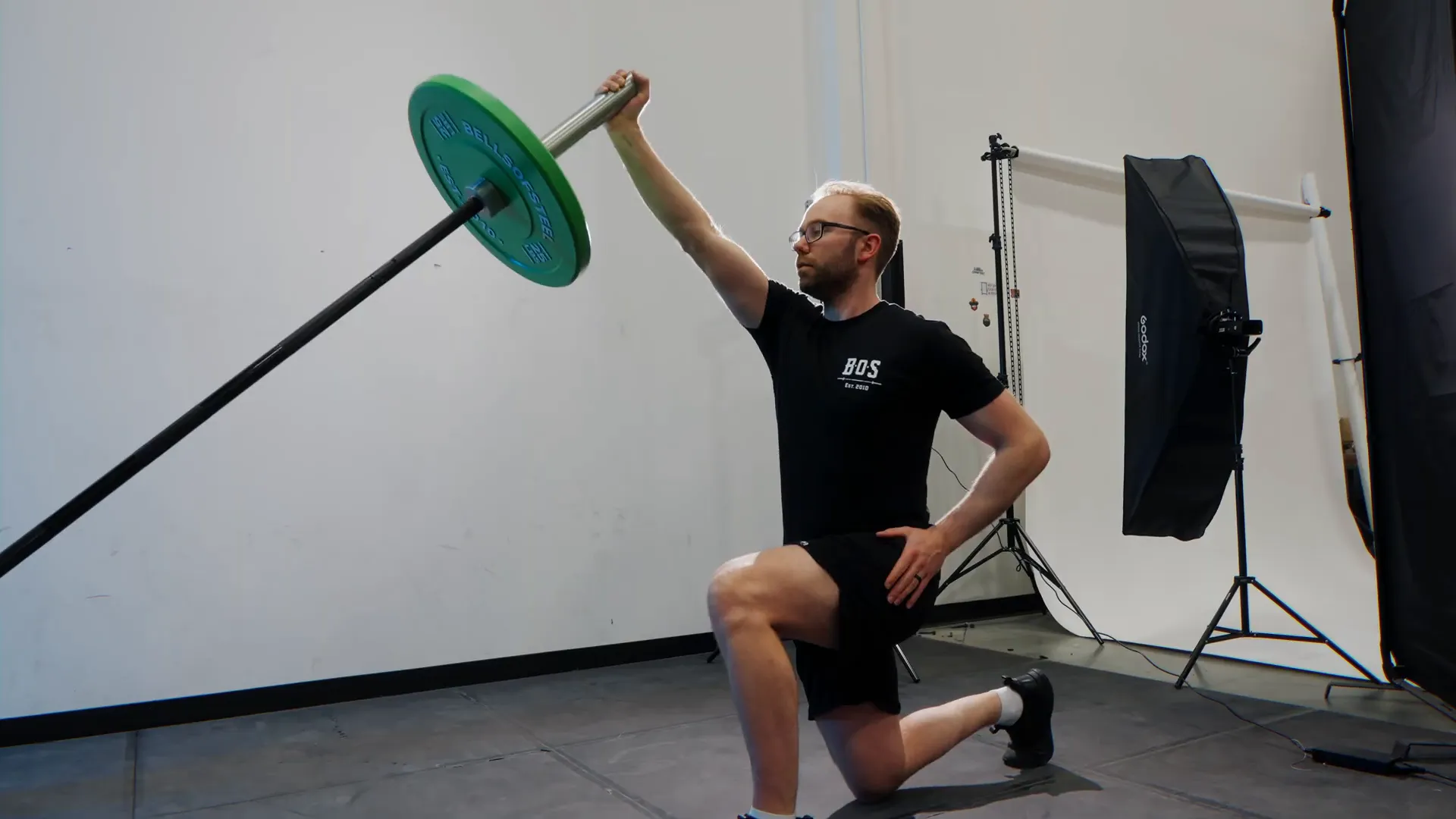 Athlete performing kneeling landmine press
