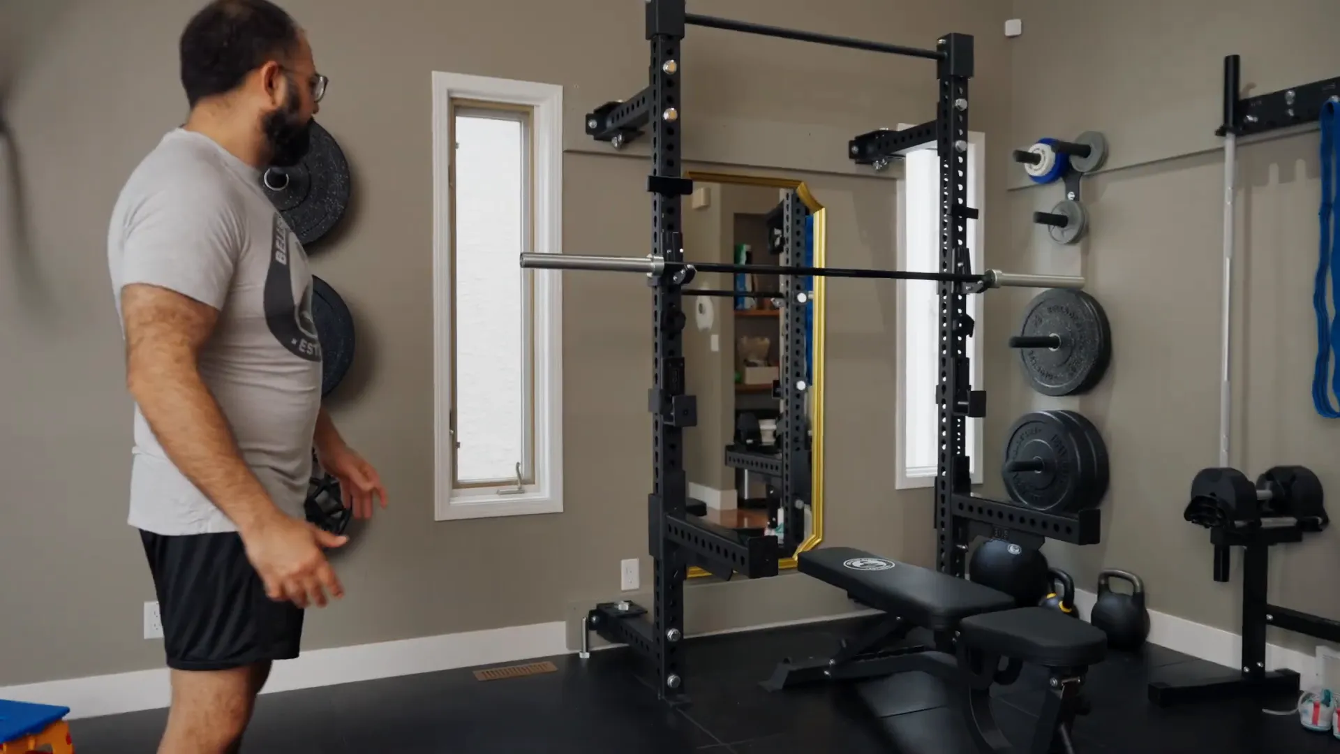 Wall-mounted plate storage and folding rack in home gym