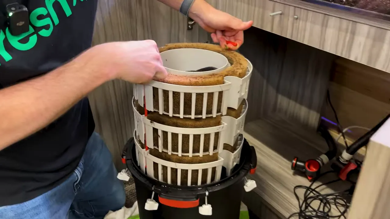Three stacked Fluval FX6 media baskets lifted from the canister