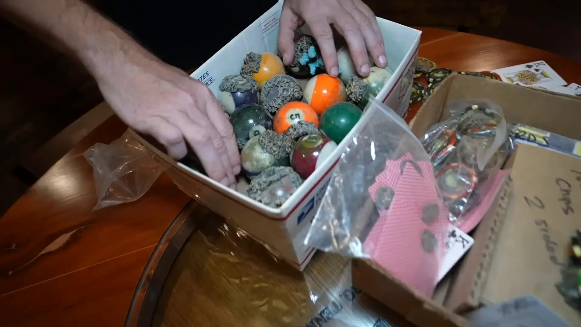 Coral-encrusted pool balls and poker chips in aquarium