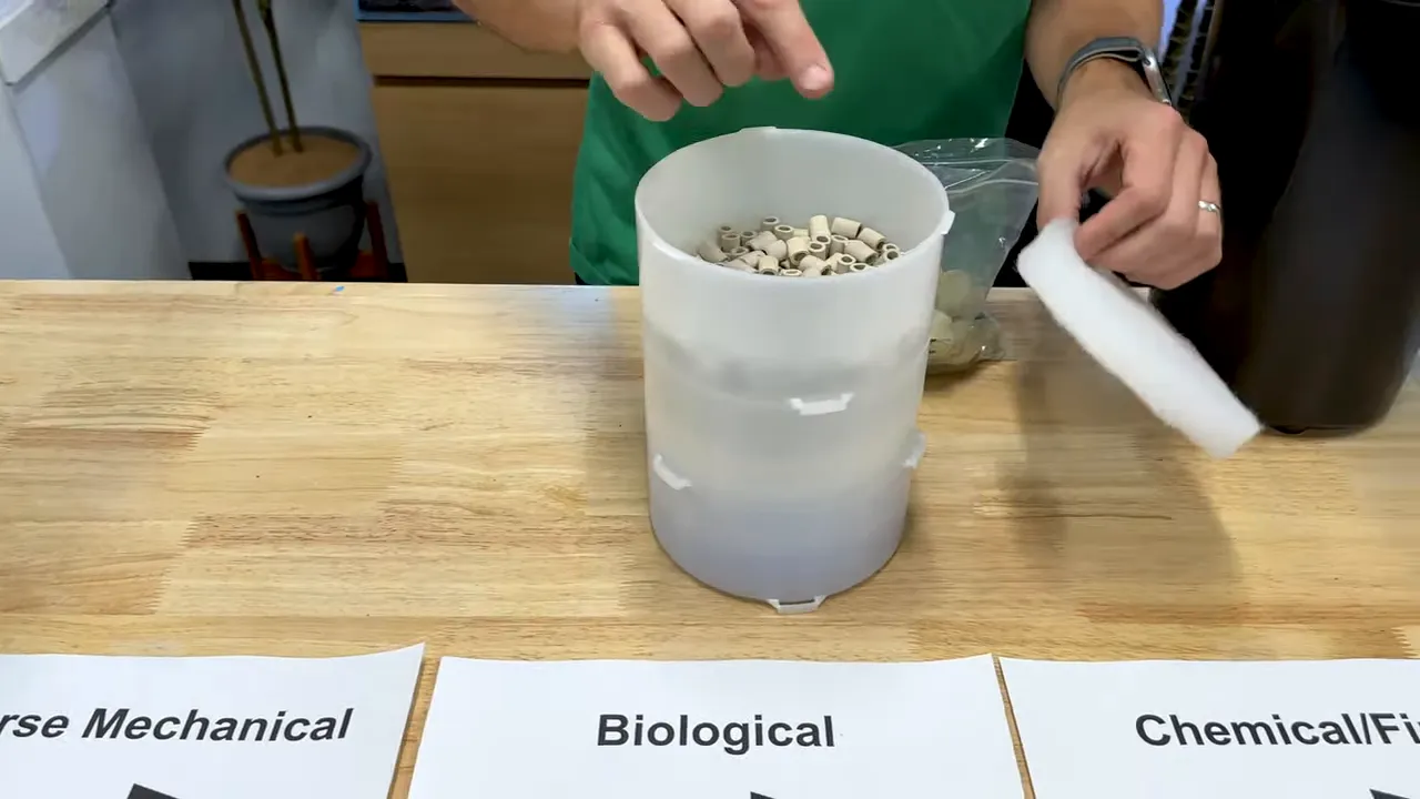Stacked canister filter trays showing layered foam and biological media