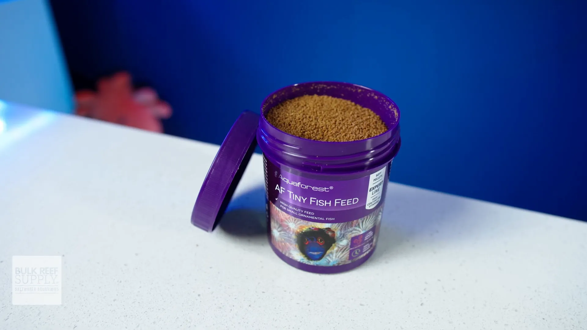 Tiny Fish Formula pellets next to a ruler to show scale