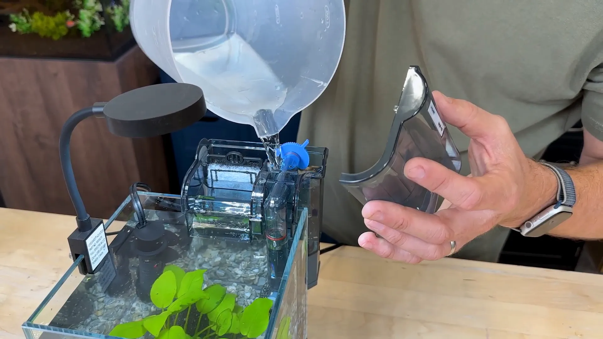 Gently filling the nano tank with water