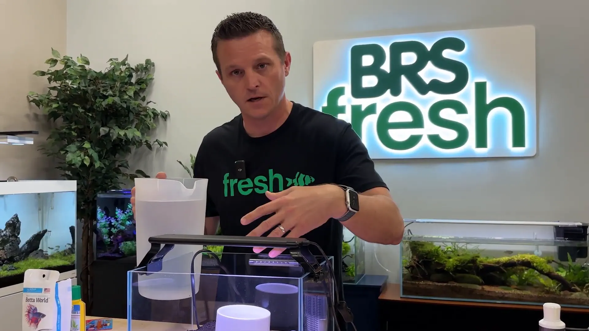 Filling aquarium using a cup to reduce splash