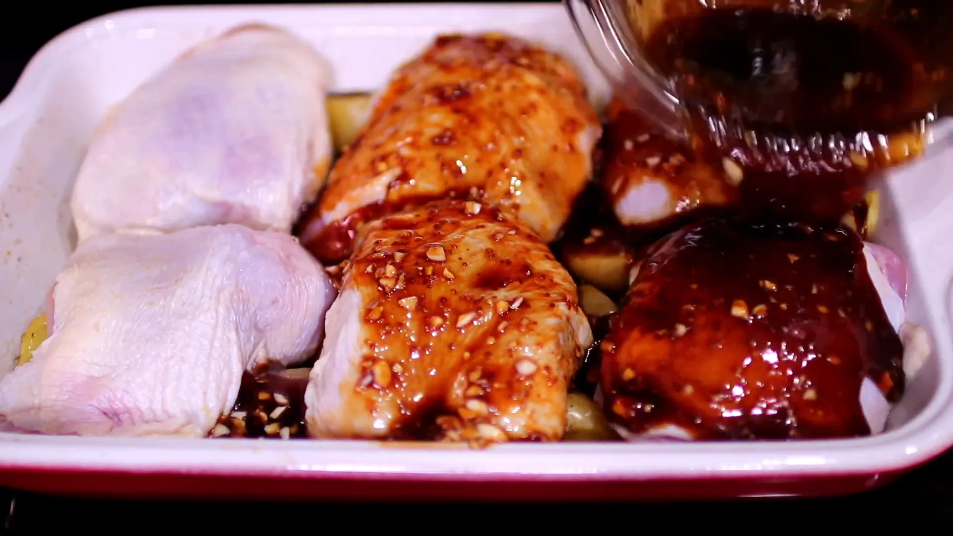 Pouring sauce over chicken and potatoes