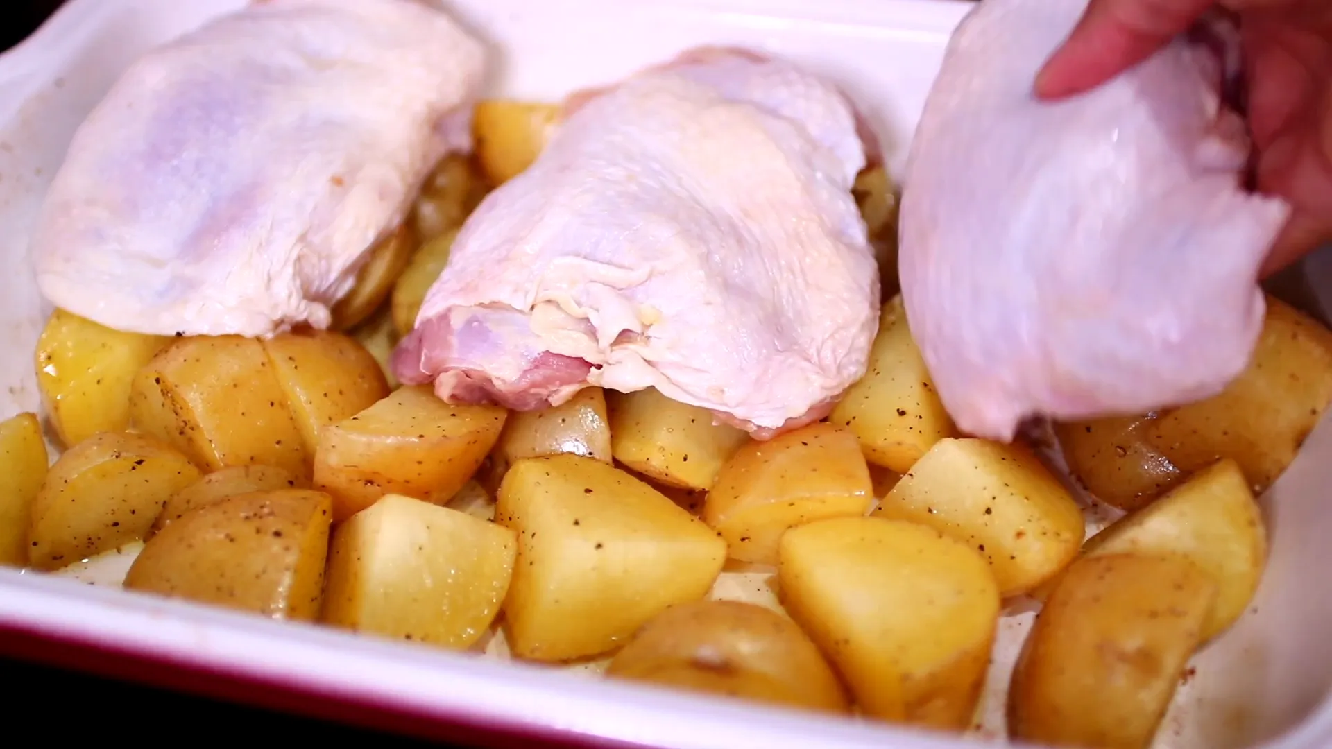 Adding chicken thighs to the pan