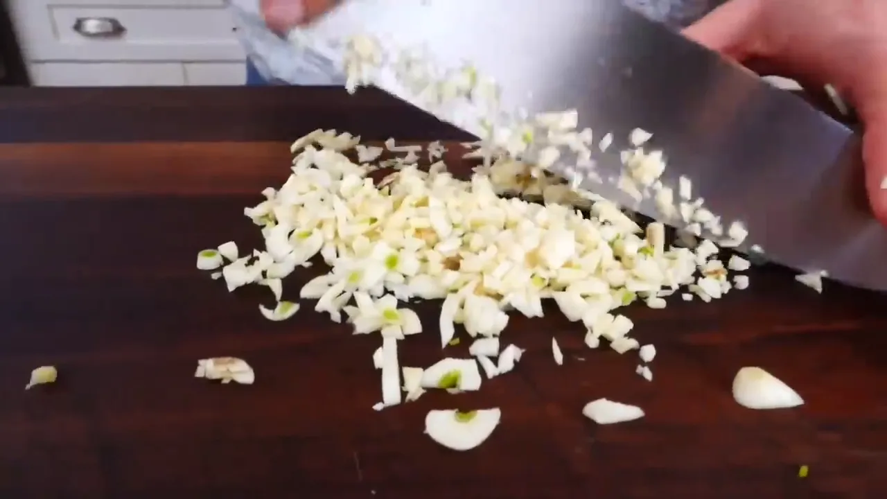 Chopping garlic for sautéed broccoli