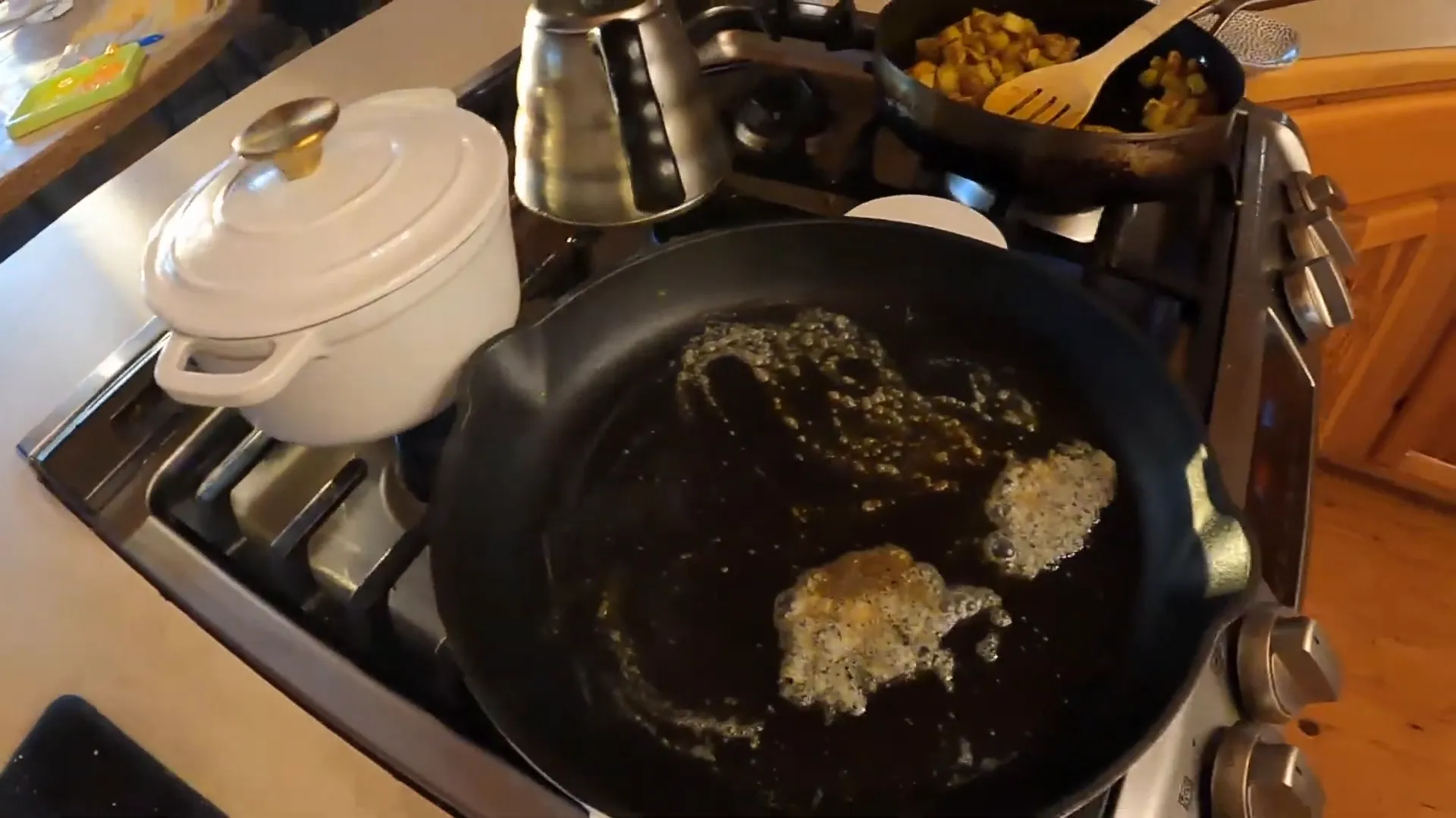 Melting butter in the skillet for cooking the steak.