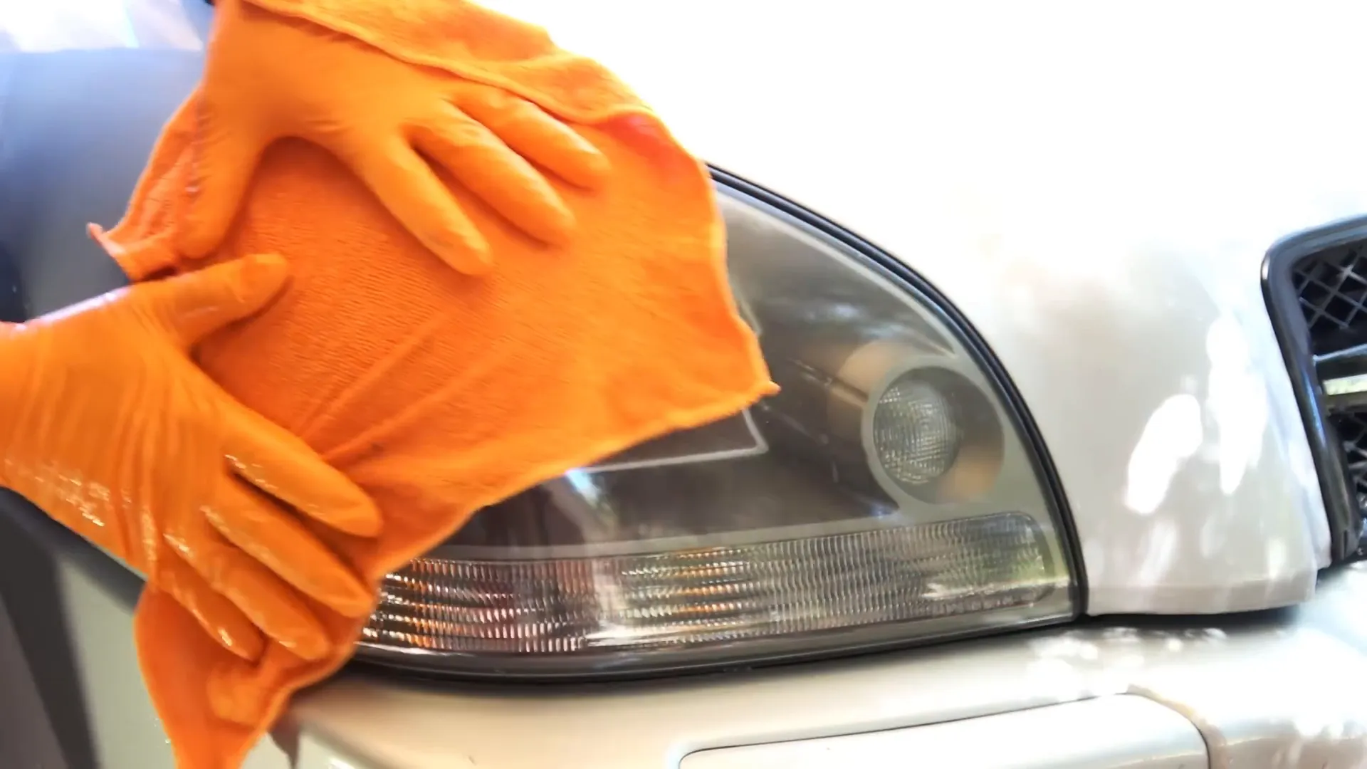 Cleaning headlights with a microfiber towel