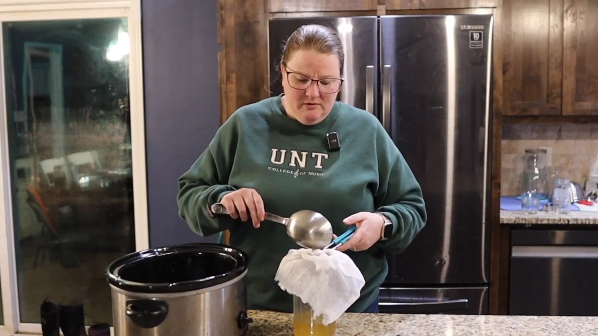 Straining tallow through cheesecloth