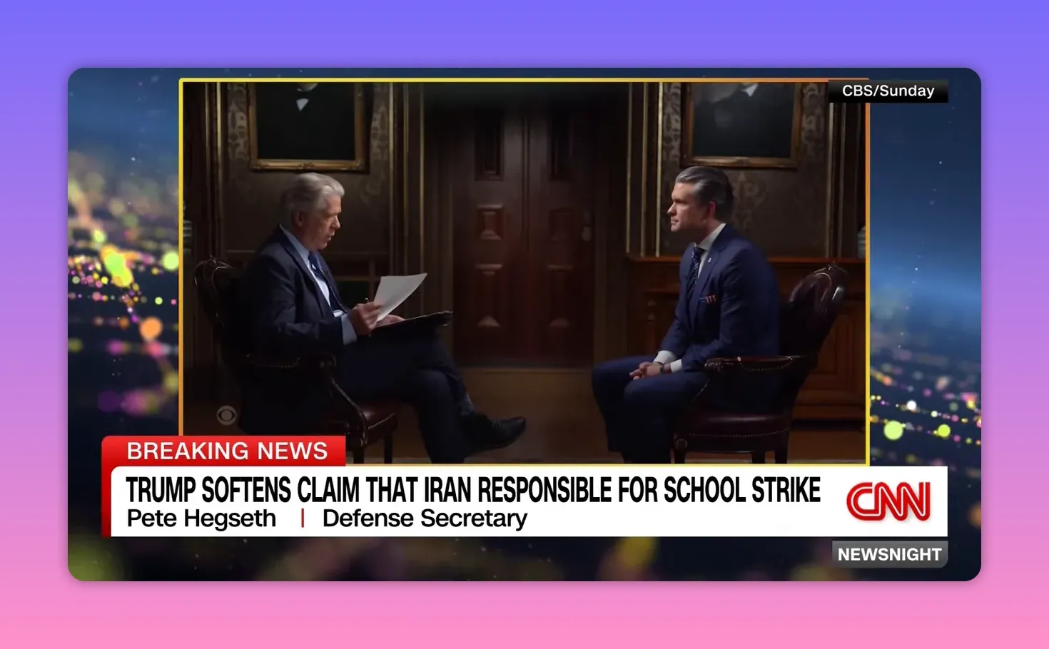 Zwei Personen sitzen sich in einem formellen TV-Interview gegenüber; linker Interviewer, rechter Gesprächspartner