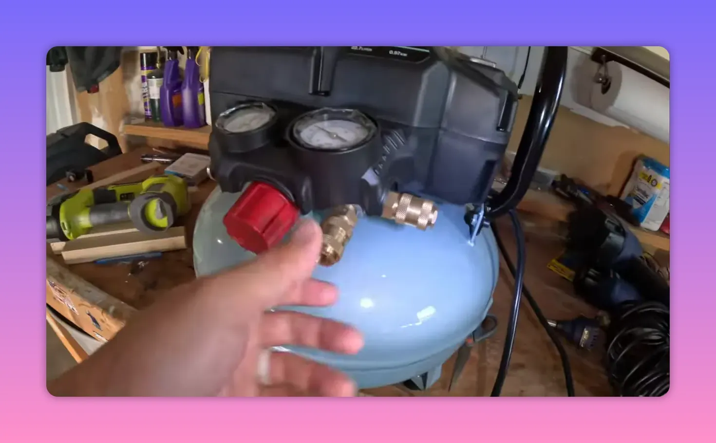 close-up of compressor pressure regulator knob, quick-connect fittings and gauges on the tank