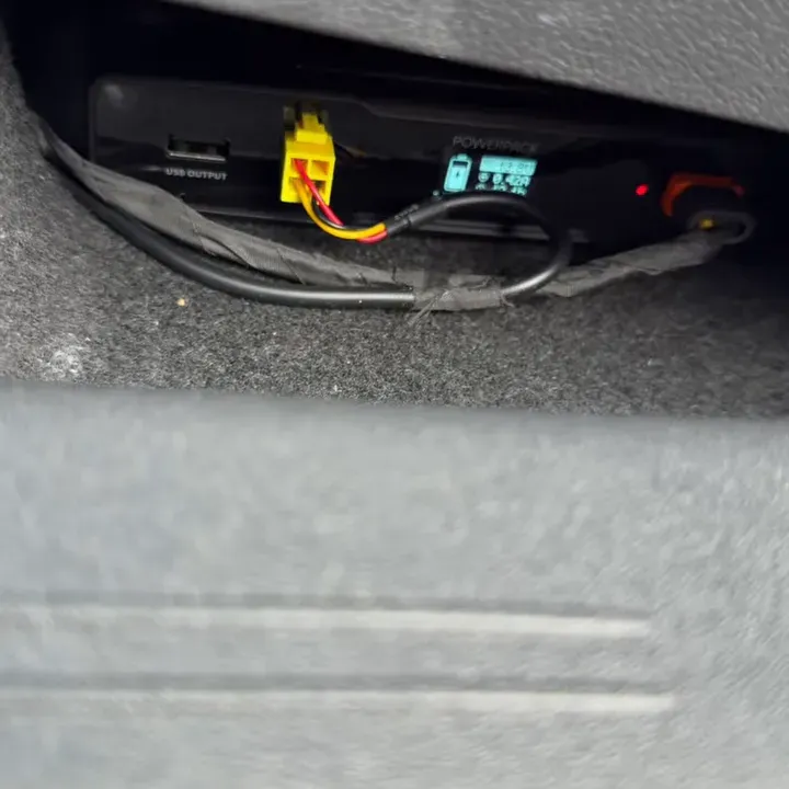 Dash camera battery pack mounted under the seat with connected wires and small display