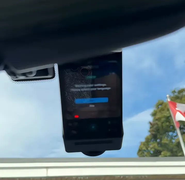 Front dash cam mounted beneath the rear-view mirror