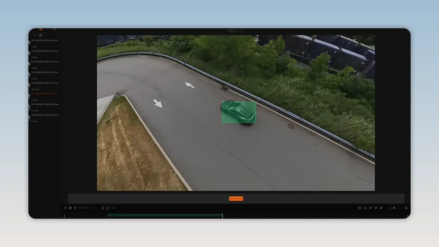 Desktop editing interface with a green tracking box around a car on a curved road
