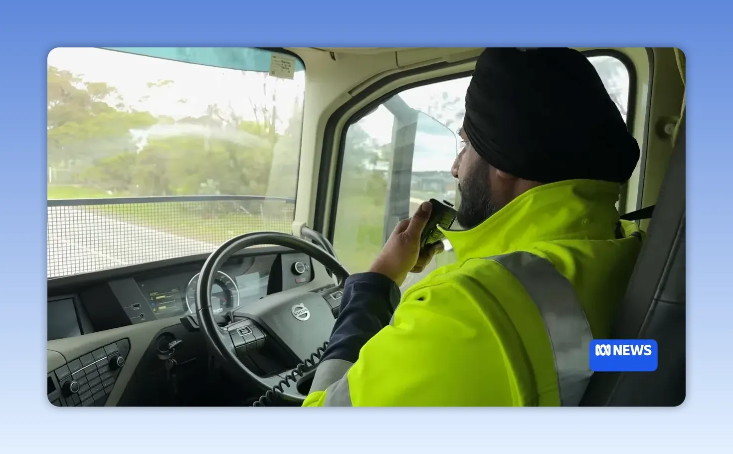 Truck driver using a UHF radio from inside the vehicle cab