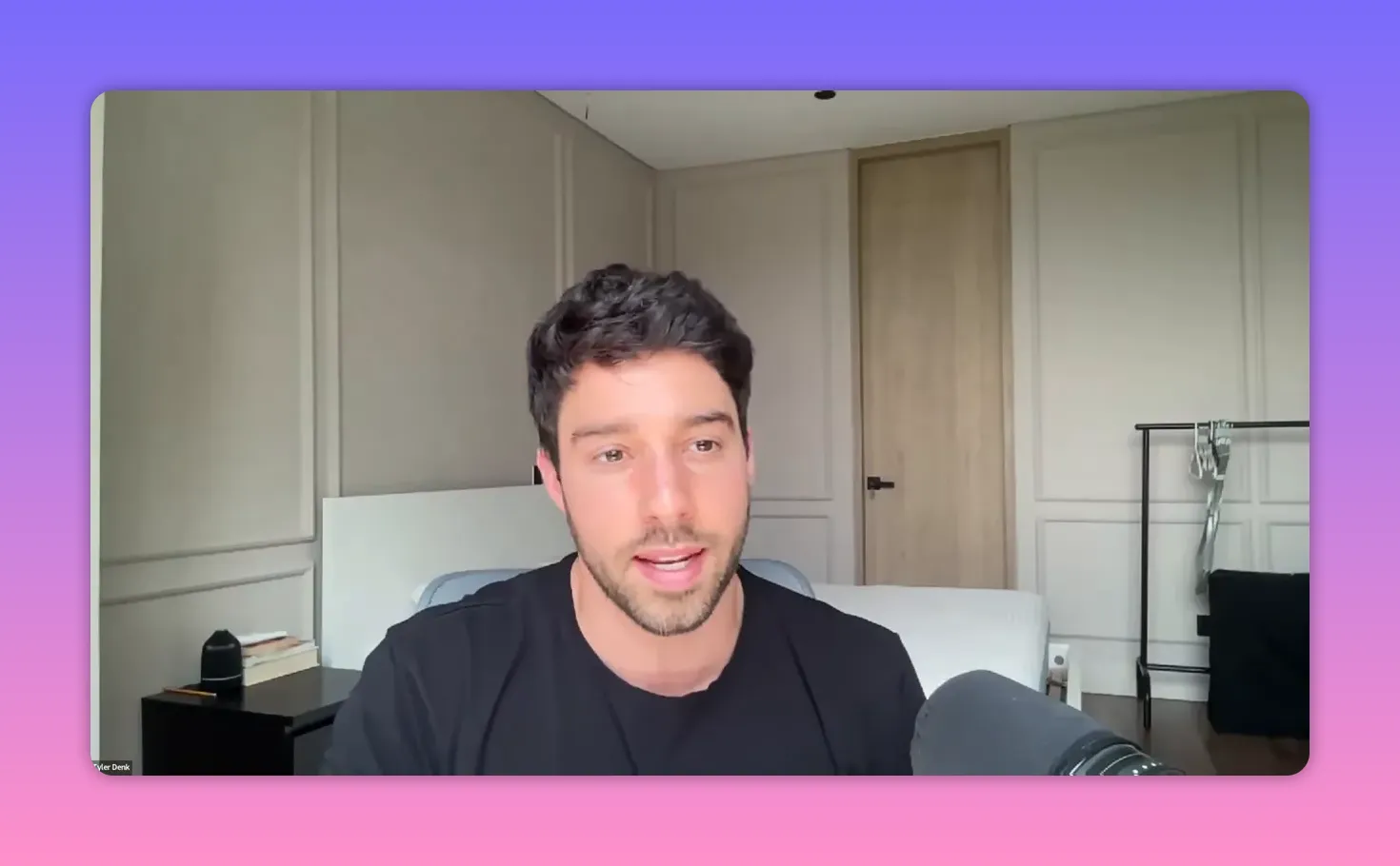 clear, well-lit webcam shot of presenter speaking with microphone in foreground